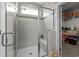 Modern bathroom featuring a tiled shower with a glass door, built-in bench, and adjacent walk-in closet at 264 Switchgrass Loop, Little River, SC 29566