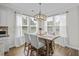 Charming dining area featuring a wood table with seating for four and natural light streaming in from the windows at 264 Switchgrass Loop, Little River, SC 29566