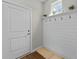Inviting entryway with shiplap accent, decorative hooks, and natural light, creating a warm welcome at 264 Switchgrass Loop, Little River, SC 29566