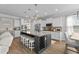 Modern kitchen with a large island, stainless steel appliances, and stylish pendant lighting creating a culinary focal point at 264 Switchgrass Loop, Little River, SC 29566