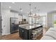 Open-concept kitchen featuring a large island with seating, stainless steel appliances, and modern pendant lighting at 264 Switchgrass Loop, Little River, SC 29566