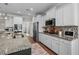 Bright kitchen featuring white cabinets, granite countertops, stainless steel appliances, and a mosaic tile backsplash at 264 Switchgrass Loop, Little River, SC 29566