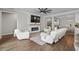 Cozy living room featuring an electric fireplace, a large TV, and ample seating for relaxation and entertainment at 264 Switchgrass Loop, Little River, SC 29566
