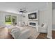 Bright living room with a modern fireplace, cozy armchairs, and sliding glass doors that offer great natural light at 264 Switchgrass Loop, Little River, SC 29566