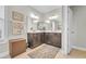 Elegant bathroom with double vanity, granite counters, and decorative mirror at 2685 Scarecrow Way, Myrtle Beach, SC 29579