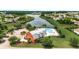 Aerial view featuring community pool with barn-style community center overlooking a lake in a neighborhood at 2685 Scarecrow Way, Myrtle Beach, SC 29579