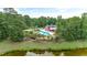 Aerial view of a community pool and clubhouse surrounded by lush greenery and a small pond at 2685 Scarecrow Way, Myrtle Beach, SC 29579