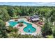 Aerial view of community pool with a unique shape, surrounded by palm trees and lush landscaping at 2685 Scarecrow Way, Myrtle Beach, SC 29579