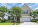 Charming exterior featuring a second story balcony, a 2-car garage, and attractive landscaping at 2685 Scarecrow Way, Myrtle Beach, SC 29579