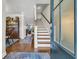Inviting foyer showcasing hardwood floors, staircase with wood treads, and open access to the dining room at 2685 Scarecrow Way, Myrtle Beach, SC 29579