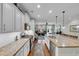 Open-concept kitchen showcasing granite counters, stainless appliances, and hardwood floors that flow into the living area at 2685 Scarecrow Way, Myrtle Beach, SC 29579