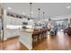 Open-concept kitchen with a large center island, pendant lighting, stainless appliances, and hardwood flooring at 2685 Scarecrow Way, Myrtle Beach, SC 29579