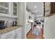 Galley kitchen featuring white cabinets, granite countertops, stainless steel appliances, and hardwood floors at 2685 Scarecrow Way, Myrtle Beach, SC 29579