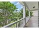 Inviting porch with white railings and columns, offering a pleasant view of surrounding trees at 2685 Scarecrow Way, Myrtle Beach, SC 29579