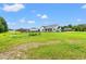 Large backyard showcasing a lush lawn, fenced area, and a charming gazebo with a privacy fence at 307 Russ Rd., Loris, SC 29569
