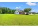 Beautiful exterior view of a brick and vinyl home with a lush green lawn and mature trees at 307 Russ Rd., Loris, SC 29569