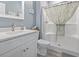 Bathroom with white vanity, quartz countertop, new fixtures, and a shower with floral curtain at 314 Black Oak Ln. # 102, Murrells Inlet, SC 29576