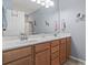 Bathroom featuring a double vanity with sleek fixtures, ample lighting, and a large mirror at 314 Black Oak Ln. # 102, Murrells Inlet, SC 29576
