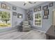 Bright bedroom with two windows, gray walls, and decorated with an accent chair and wall pictures at 314 Black Oak Ln. # 102, Murrells Inlet, SC 29576
