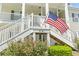 Exterior view of a home with stairs, a flag, landscaping and white siding at 314 Black Oak Ln. # 102, Murrells Inlet, SC 29576