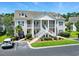 Inviting two-story condo building with white siding, well-maintained landscaping, and a prominent staircase entrance at 314 Black Oak Ln. # 102, Murrells Inlet, SC 29576