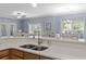 Kitchen view highlighting the sink, faucet, and view of the living area and dining area at 314 Black Oak Ln. # 102, Murrells Inlet, SC 29576