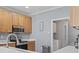 Kitchen with stainless appliances, wood cabinets, white countertops, and access to a laundry area at 314 Black Oak Ln. # 102, Murrells Inlet, SC 29576