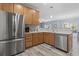 Kitchen area featuring stainless steel appliances and natural wood cabinets at 314 Black Oak Ln. # 102, Murrells Inlet, SC 29576