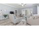 Cozy living room with comfortable seating, ceiling fan, wood-look floors, and french doors at 314 Black Oak Ln. # 102, Murrells Inlet, SC 29576