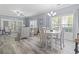 Open-concept living and dining area filled with natural light and a modern dining set at 314 Black Oak Ln. # 102, Murrells Inlet, SC 29576