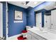Classic blue bathroom with tiled walls, a white vanity, and framed artwork at 315 72Nd Ave. N # A, Myrtle Beach, SC 29572
