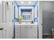 Bright blue bathroom with a white vanity, ample storage, and decorative accents at 315 72Nd Ave. N # A, Myrtle Beach, SC 29572