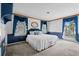 Spacious bedroom with a king bed, large windows, and blue accents at 315 72Nd Ave. N # A, Myrtle Beach, SC 29572