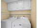 Convenient laundry area features white cabinets, modern washer, and dryer at 315 72Nd Ave. N # A, Myrtle Beach, SC 29572