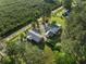 An aerial view of a wooded property with two homes and green lawns at 3269 Sims Rd., Marion, SC 29571