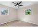 Bedroom featuring light wood floors, a ceiling fan, and two windows overlooking a lawn at 3269 Sims Rd., Marion, SC 29571
