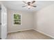 Well-lit bedroom with a ceiling fan, one window overlooking a green lawn, and light wood floors at 3269 Sims Rd., Marion, SC 29571