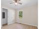 Well-lit bedroom with a ceiling fan, a window with a green lawn view, and a utility closet at 3269 Sims Rd., Marion, SC 29571