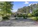 Inviting exterior view of home with lush landscaping and gravel driveway at 3269 Sims Rd., Marion, SC 29571