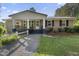 Inviting front of brick house with covered porch and meticulously kept landscaping at 3269 Sims Rd., Marion, SC 29571