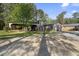 A spacious garage with an attached carport, surrounded by lush trees and greenery at 3269 Sims Rd., Marion, SC 29571