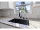 New kitchen sink features a black faucet, a deep basin, and granite countertops with a beautiful view at 3269 Sims Rd., Marion, SC 29571