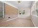Bright living room with brick accent wall, new windows, and durable wood-look flooring at 3269 Sims Rd., Marion, SC 29571
