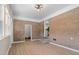 Bright living room with brick accent wall, modern light fixture, and durable wood-look flooring at 3269 Sims Rd., Marion, SC 29571