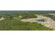 Aerial view of a new construction community with a pond and mature trees at 417 Spruce Pine Way, Conway, SC 29526