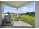 Relaxing covered back porch with rocking chairs overlooking a large grassy backyard and scenic pond at 417 Spruce Pine Way, Conway, SC 29526