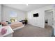 Cozy bedroom featuring a comfortable bed, desk, television, and a bright window at 417 Spruce Pine Way, Conway, SC 29526