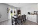 Dining area with a large table, modern lighting, and view of the outdoor living space at 417 Spruce Pine Way, Conway, SC 29526