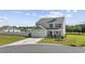 Charming two-story home featuring a well-maintained lawn, two car garage, and landscaped front yard at 417 Spruce Pine Way, Conway, SC 29526