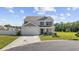 Charming two-story home with a well-manicured lawn, a covered front porch, and an attached garage at 417 Spruce Pine Way, Conway, SC 29526